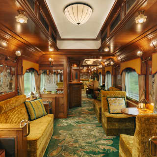 On a green patterned carpet, gold velvet banquettes bathe in the warmth of wood panelling and mellow lights in the Piano Bar.