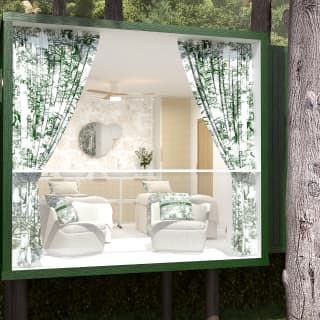 A glass wall of a green-framed luxurious tree house reveals massage beds and easy chairs with unrivalled views of the gardens