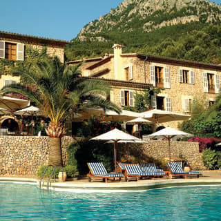 La Residencia pool and hotel under blue skies