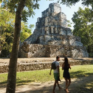 a couple walking by the Mayan ruins of Muyil