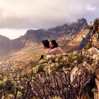 Young couple contemplating the view with mountains in the background