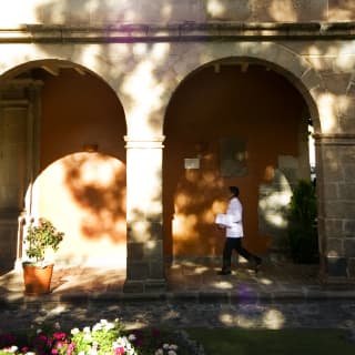 A member of staff crossing the Monasterio courtyard