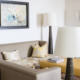 Grey and yellow patterned sofa in a stylish hotel room lounge with modern artwork