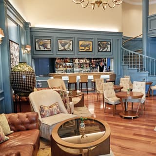 A barman in a waistcoat awaits orders at the bar of the hotel’s stylish Bar Belo