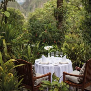 Guests can eat in the lush hotel gardens with stunning views of the mountains of Huayna Picchu