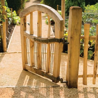 Charming oak gate leading to a vegetable garden beyond