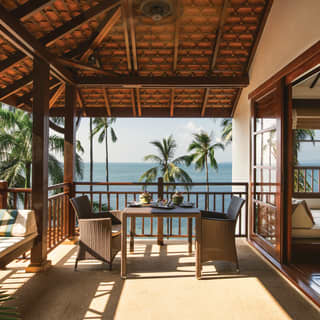 Shaded balcony with rattan seating overlooking the Gulf of Thailand