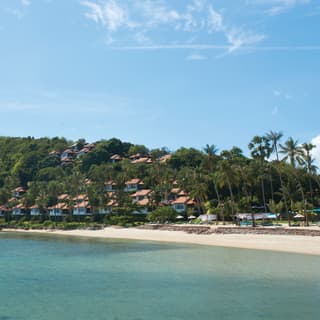 Beach villas on a jungle-coated hillside overlooking the Gulf of Thailand