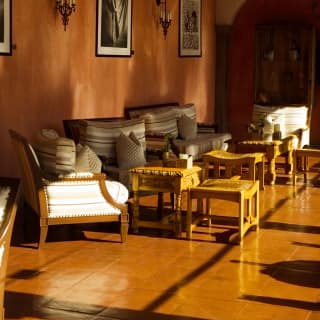 Tables and chairs in the dimly lit Senzo bar