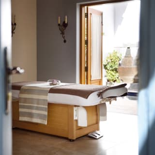 Modern spa treatment room opening onto a private courtyard