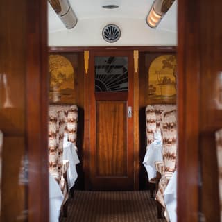 Train carriage with French-polished wall panels and a woodland marquetry design