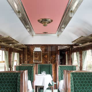 An art deco carriage features French polished walls, ziggurat shaped mirrors, exquisite marquetry and inviting seats