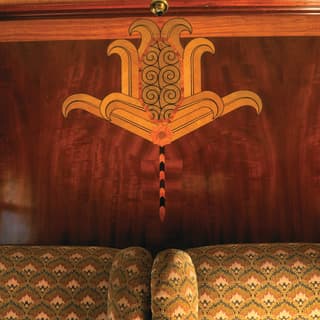 Classical Roman-style design in marquetry on a French-polished wooden wall panel