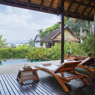 On the Mekong Spa deck, lounge chairs are positioned to view the plunge pool and lily pond, with side tables of refreshments.