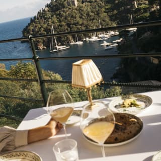 Diners at a table on the terrace of Splendido Grill sit back from their plates and drinks to digest the extraordinary views.