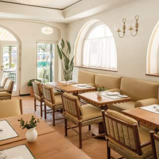 A row of set tables for two in the DaV Mare dining room