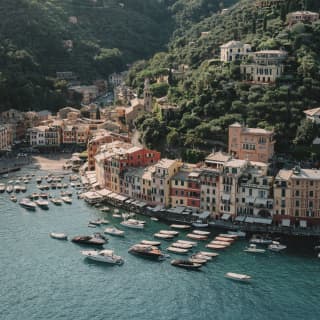 An aerial view of Portofino shows the elegance of the pastel buildings that cluster at the waters edge and dot the verdant hills