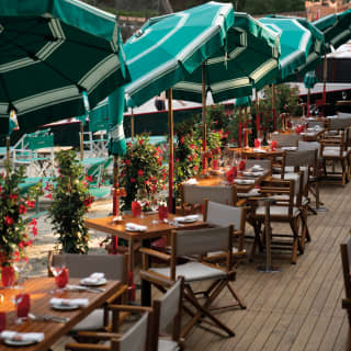 Beach restaurant tables and chares with parasols