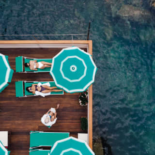 Top shot of the deck with two women lying on deck chairs