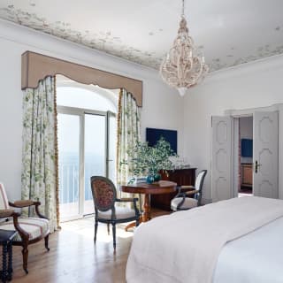 The Belvedere suite boasts smooth floorboards, vintage pieces and hand-painted frescos, and a Juliet balcony with sea views.