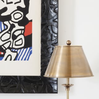 Living room detail from the Miramare suite showing the corner of a Matisse serigraph print in a black frame, and side lamp.