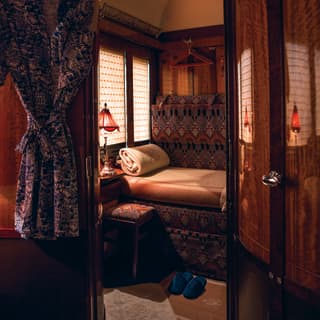 Vintage train cabin with banquette seat and hanging kimono dressing gown