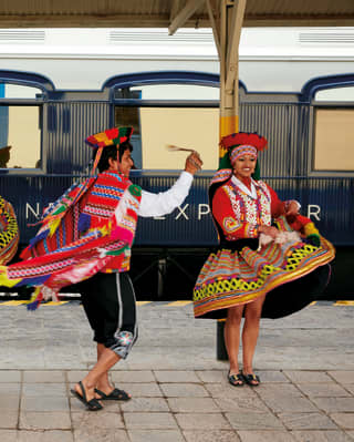 Smiling lady dancing in traditional Peruvian dress 
