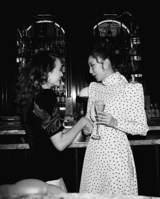 Two ladies with a cocktail in their hand