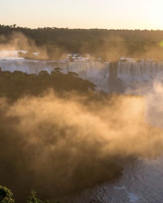 Mist rising from the Iguassu Falls at sunrise