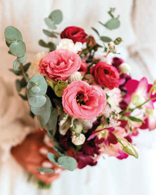 Elegant wedding bouquet held by woman in white dress