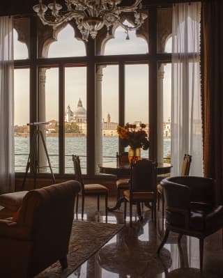 Tall stone-mullion windows flood the Dogaressa Suite with incredible views of the Doge's Palace and Basilica San Marco.