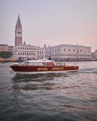 Venetian water taxi with Hotel Cipriani on the side