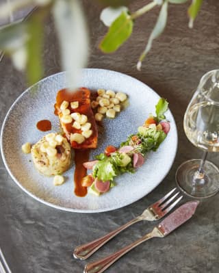Circular plate of contemporary Peruvian cuisine. served with white wine