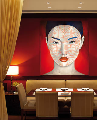 Contemporary portrait of an asian lady hanging above a restaurant table