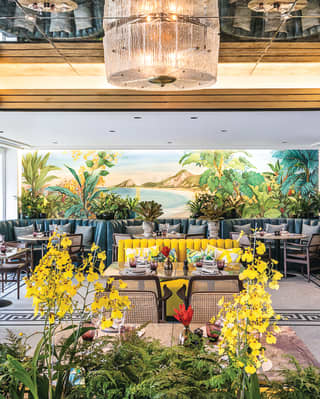 Stylish carioca restaurant with modern chandelier and gold and yellow accents