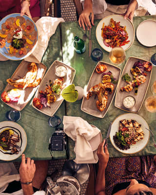 An overhead shot of people sitting around a dining table at Pérgula restaurant
