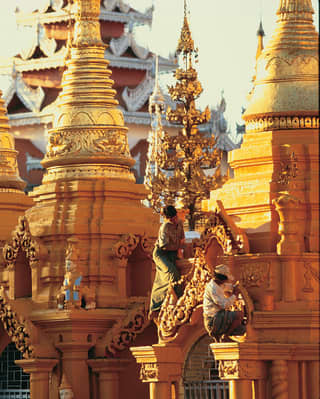Painters restoring the ornate temples of Shwedagon Pagoda