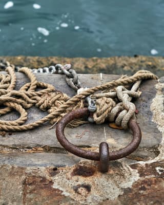 Old rusty metal and ropes on Portofino harbour 