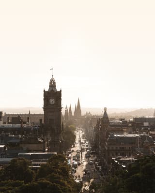 Aerial view of the Royal Mile and Edinburgh skyline under a sunny sky