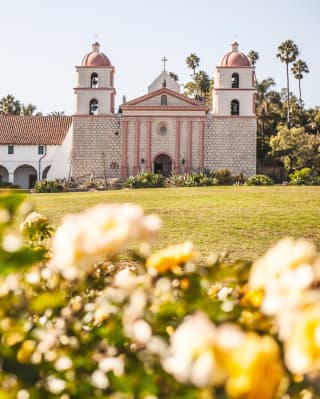 Spanish colonial-style church with two spires and arched cloister