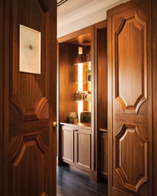 Open wood-panelled spa entrance doors with a sign reading 'The Spa'