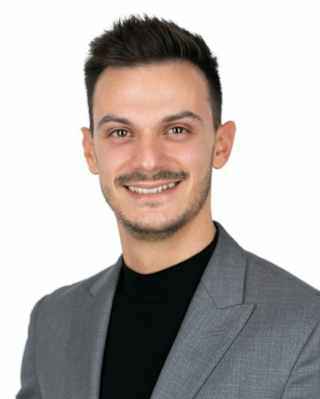 Senior Area Sales Manager, Southern Europe, Andrea Gervasoni with dark hair and beardstache, wears a grey suit and black top.