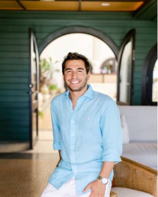 Francisco Sá Teixeira, Divisional Director of Sales for Southern Europe, smiles to camera in a blue shirt and white trousers.