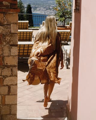 A woman walking towards the pool