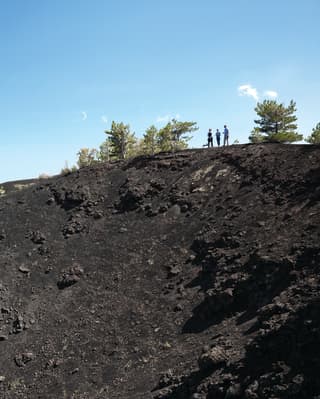 Guest touring the slopes of Mount Etna under blue skies