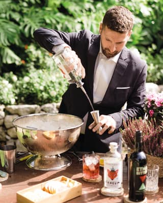 a barman making a cocktail in a garden