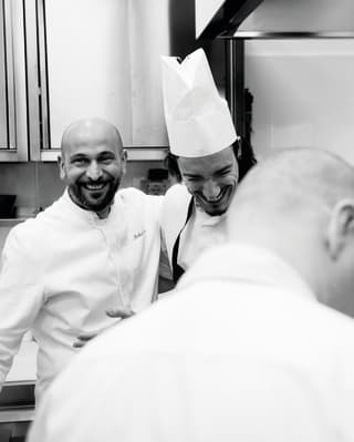 Chef Roberto Toro smiling at his kitchen