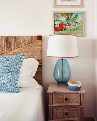 Blue cushion, bedside lamp and coin tray room details