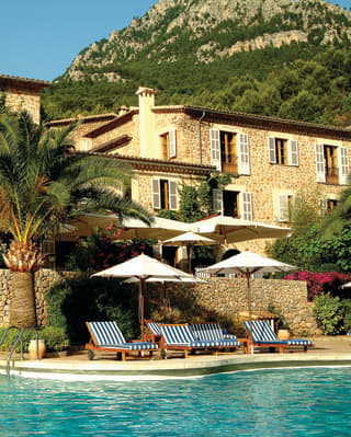 La Residencia pool and hotel under blue skies