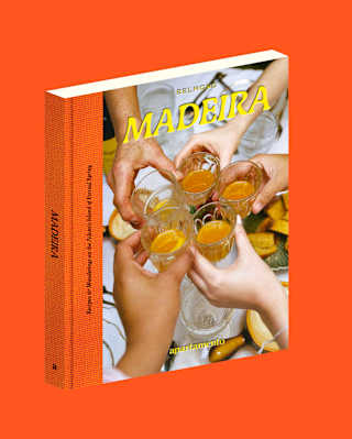 A book titled Madeira with a cover photo of several hands raising glasses in a toast, set against a bright orange background.